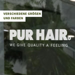 Transparente Fensterfolie mit weißem PUR HAIR Logo und Schriftzug „We Give Quality A Feeling“