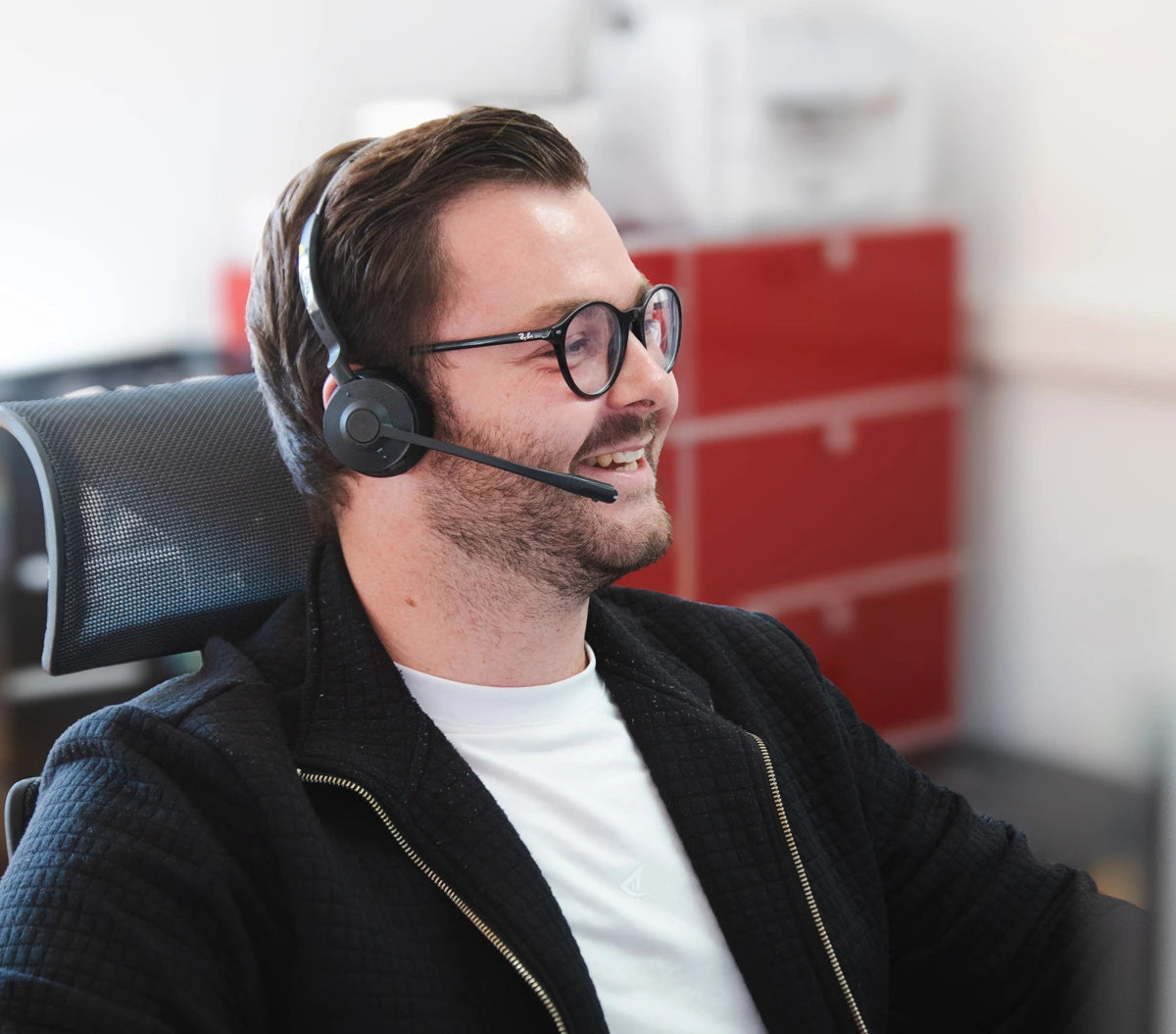 PUR HAIR Kundenservice-Mitarbeiter mit Headset und Brille bei der persönlichen Beratung im Büro.