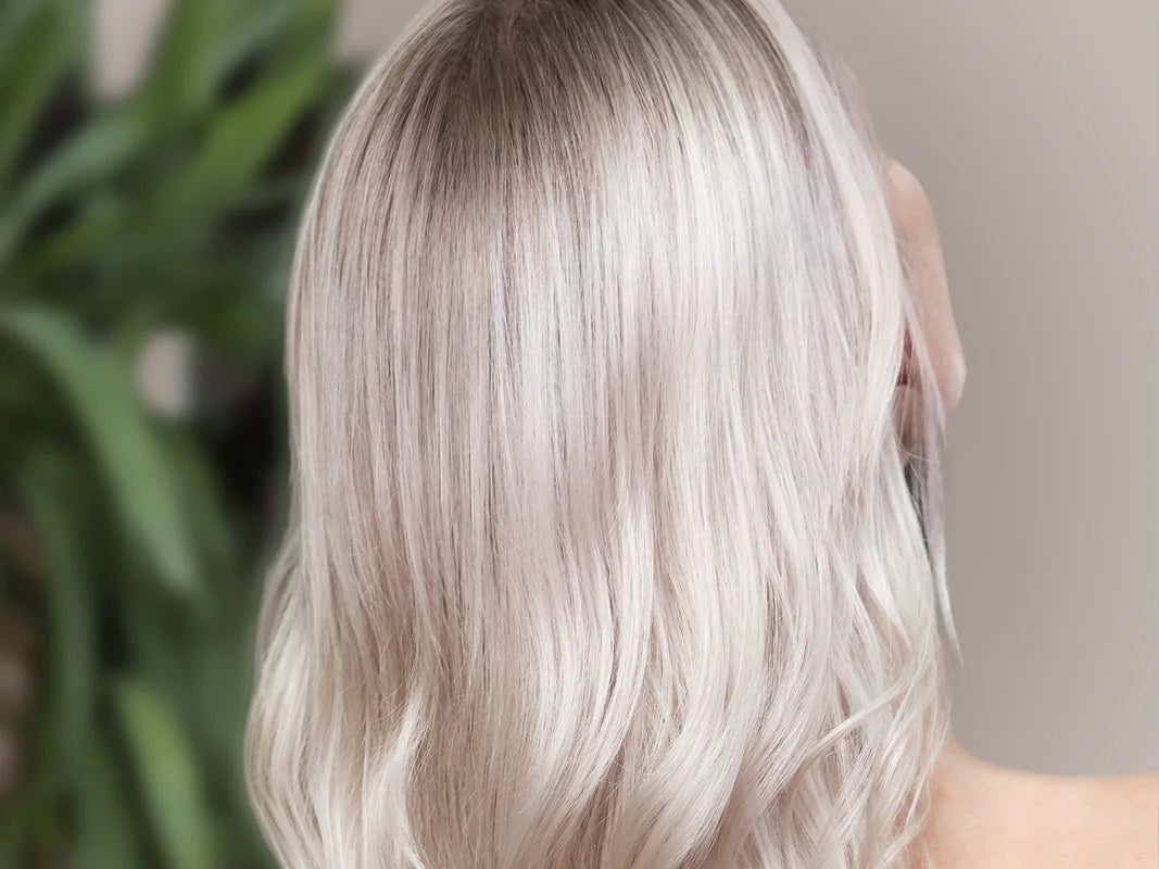 Kühles, platinblondes Haar mit sanften Wellen, glatter Haarstruktur und intensivem Glanz.