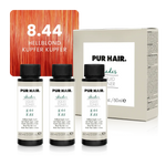 Drei weißen 60-ml-Flaschen, beiger Produktverpackung und intensiv leuchtender kupfer-oranger Strähne