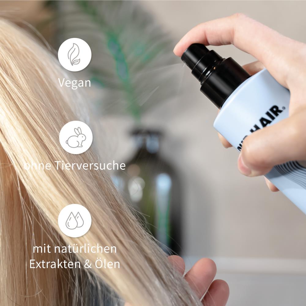 Magic K-Balm wird auf blondes Haar gesprüht.