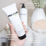 PUR HAIR Organic Magic Treatment in 125 ml Tube wird in der Hand gehalten